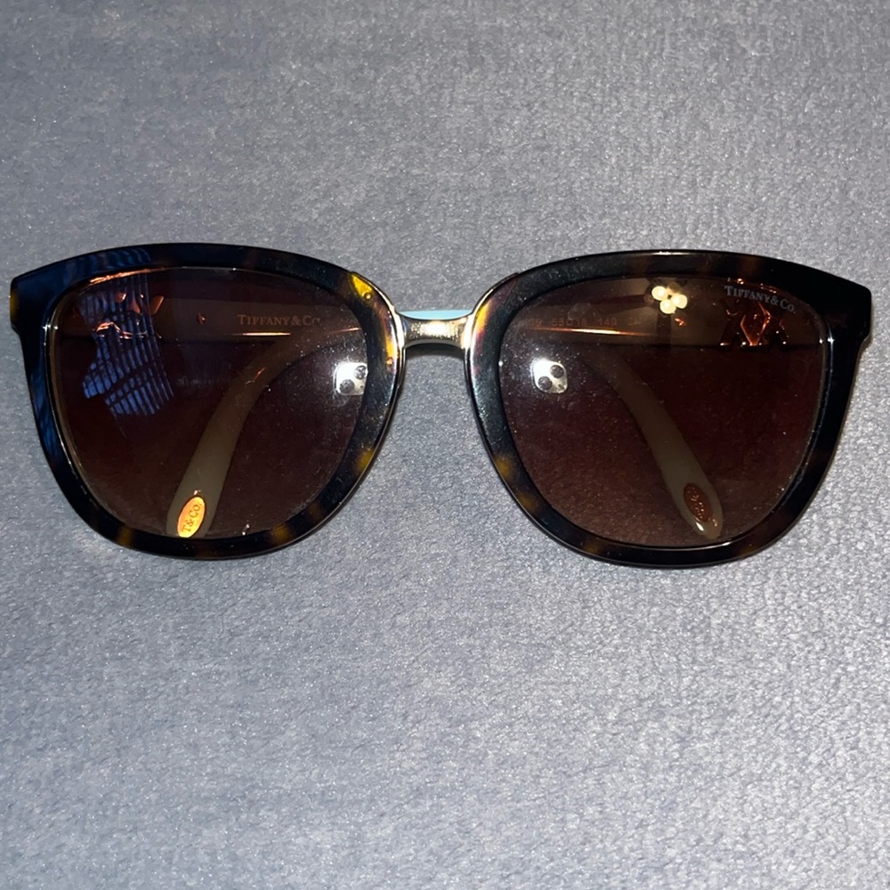 tiffany and co. sunglasses. teal and brown with gold x’s on sides